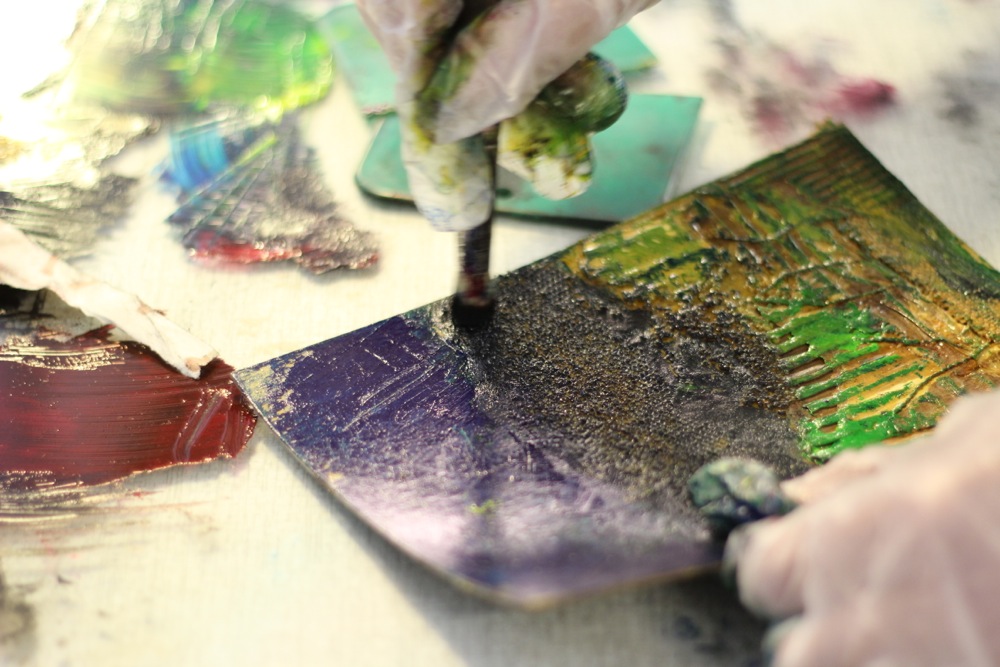 Collagraph plate being inked with a stencil brush