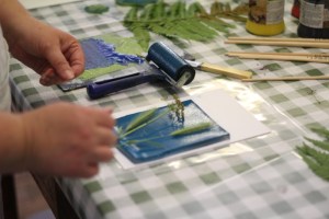 Dianne Reeves arranging grasses on an inked up gelatine plate
